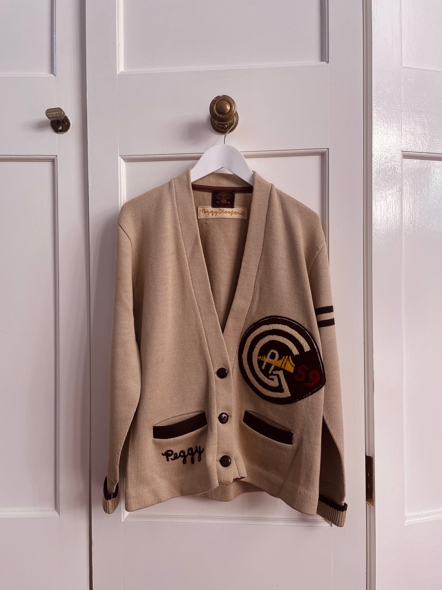 Tan 1959 varsity letterman sweater with Golden Gate Bridge patch and name inscription