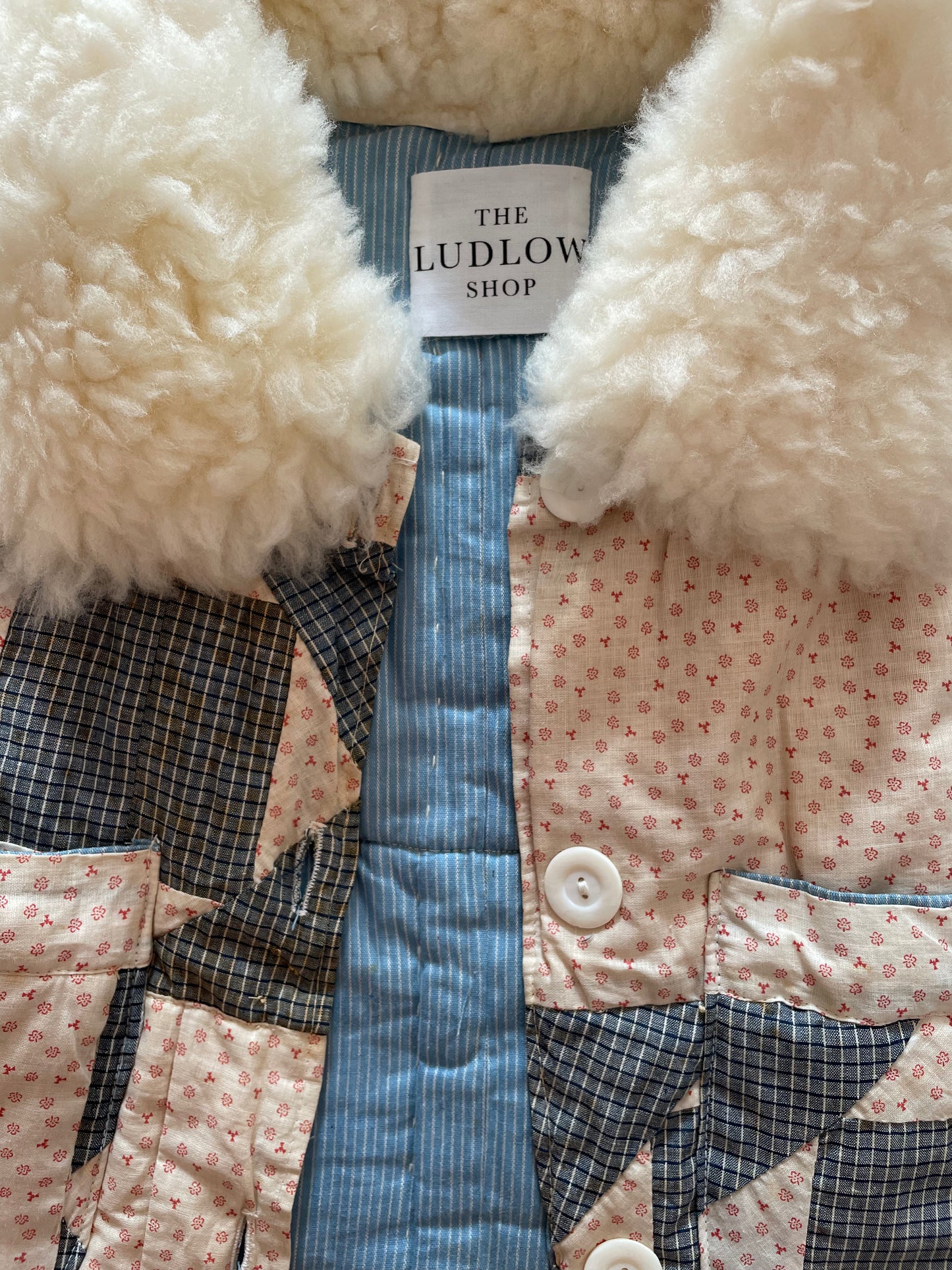 Ludlow Shearling Quilt Crop with cream Hollow Bone genuine sheepskin collar. 3 button closure. Single front pockets.