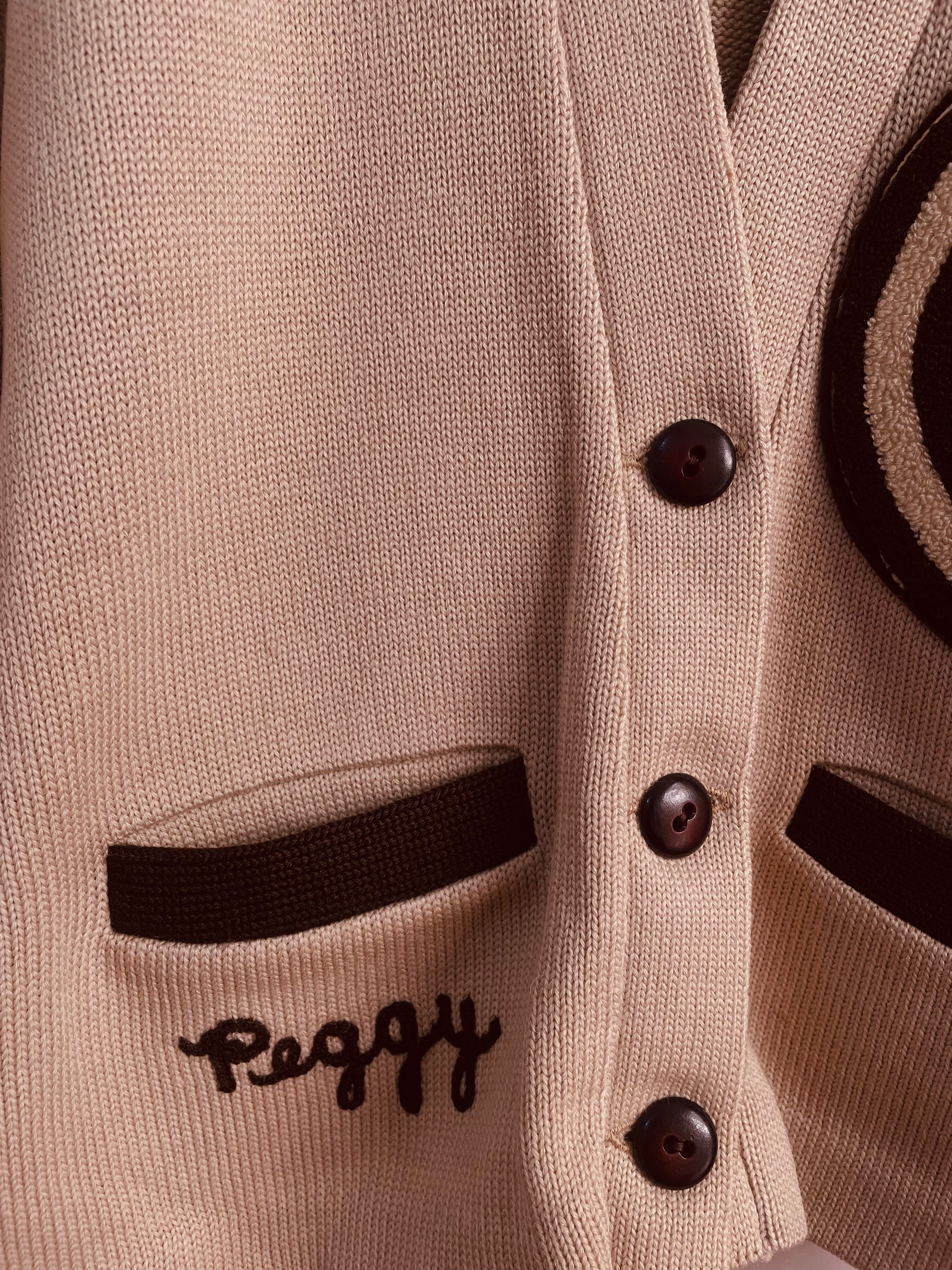 Name inscription "Peggy" on tan 1959 varsity letterman sweater